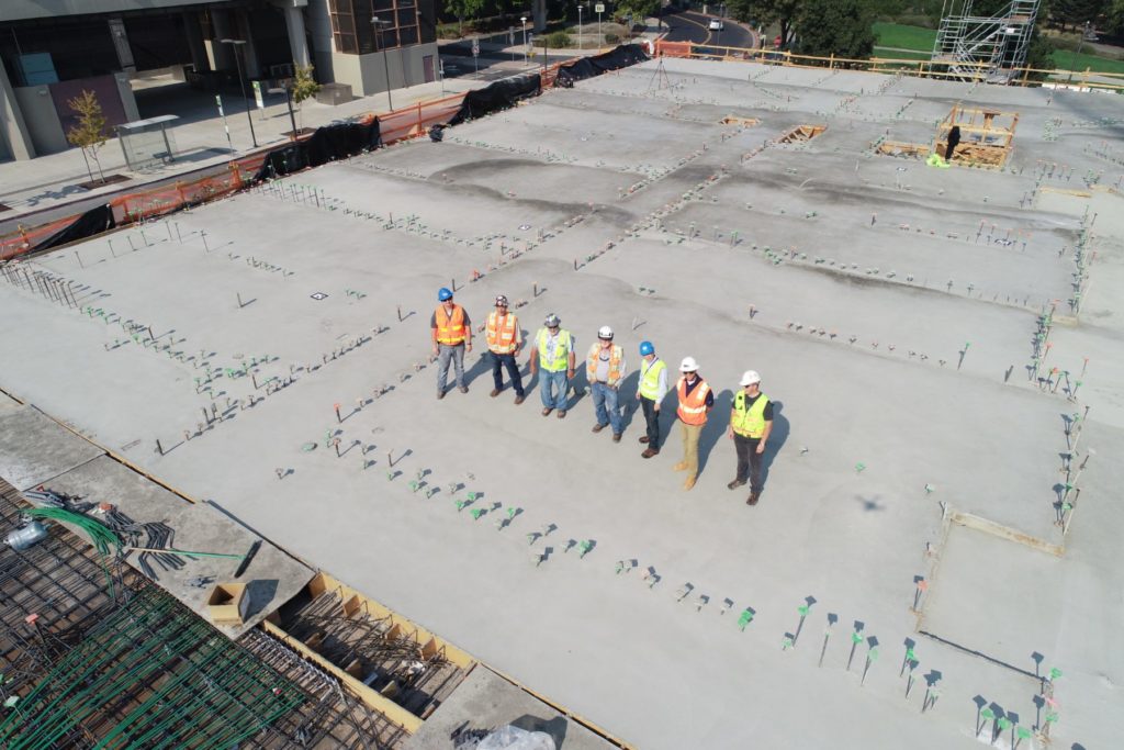Surveyors on construction site in California from above