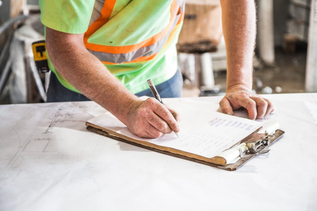 Construction worker signing a form