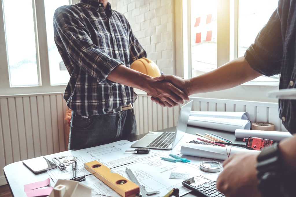 Contractor and subcontractor shaking hands agreement
