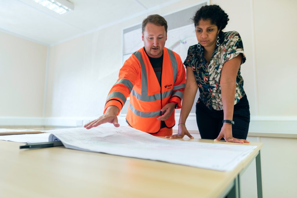 2 contractors looking at blueprint